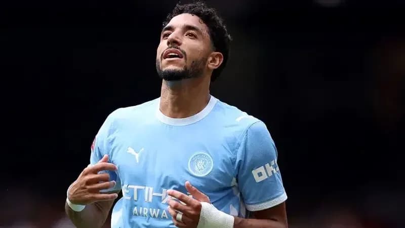 Player celebrating in Manchester City jersey on field