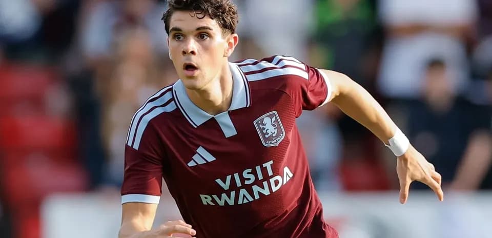 Player running during a football match in maroon kit