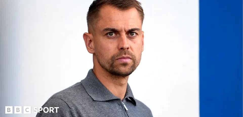 Individual posing for a portrait with neutral background