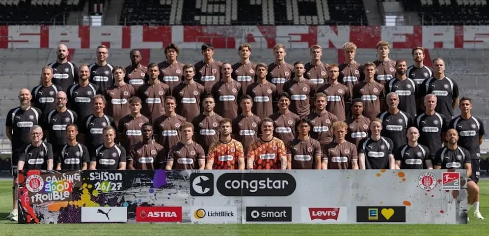 St. Pauli team photo with sponsors banner