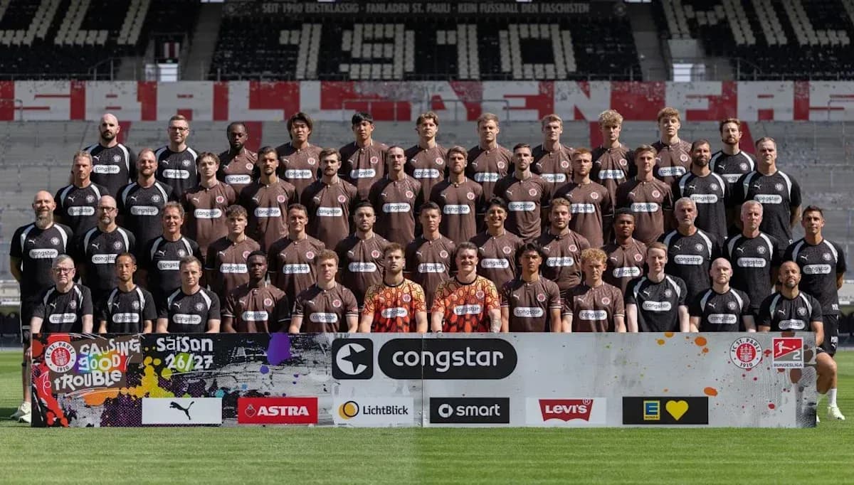 St. Pauli team photo with sponsors banner