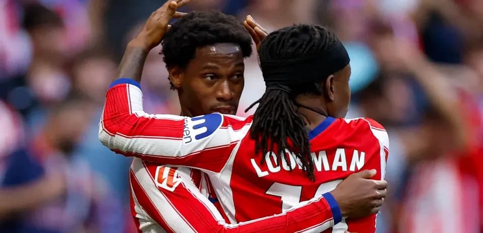 Two players celebrating a goal together on field