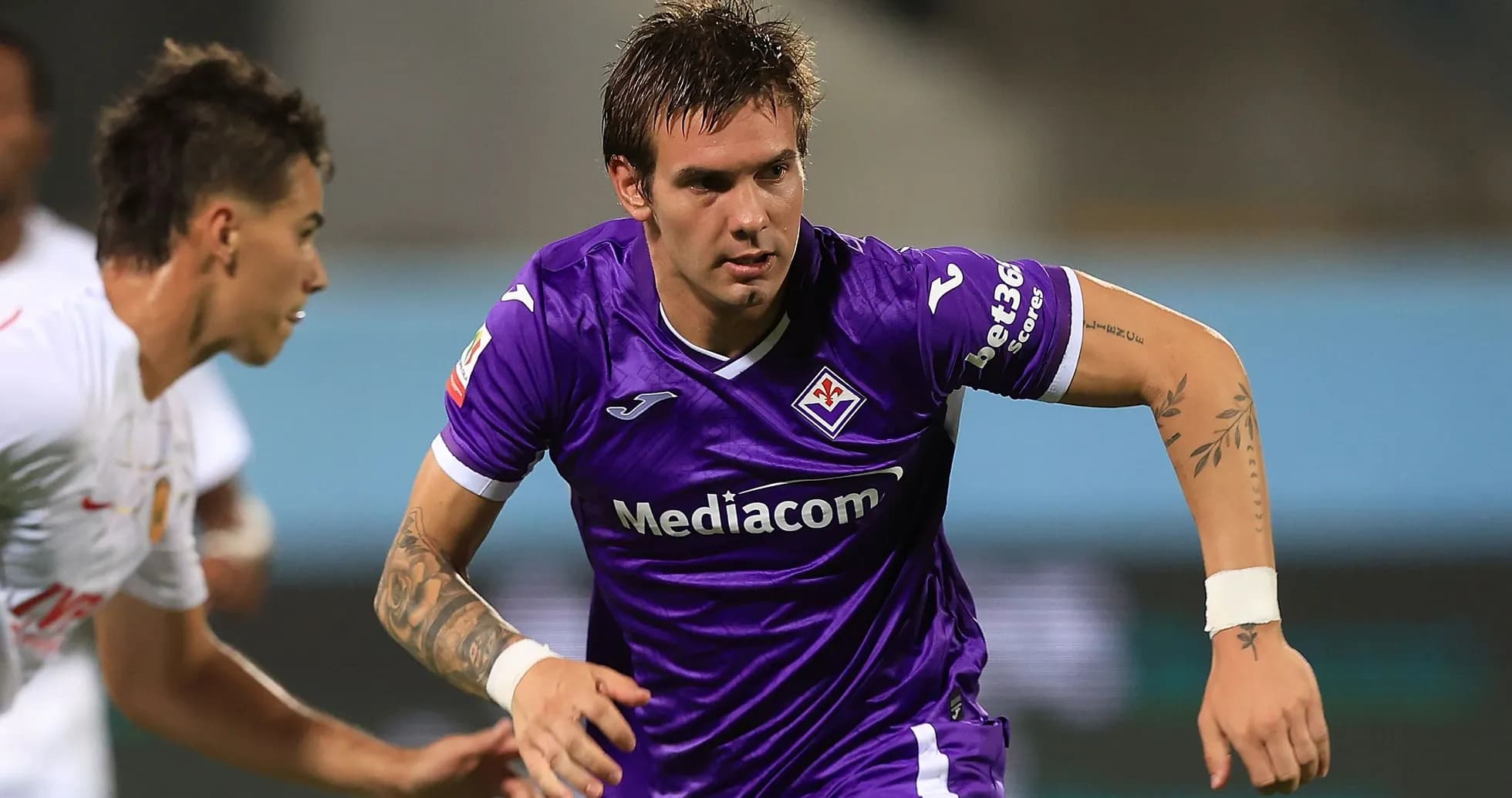 Player in purple jersey running during a match