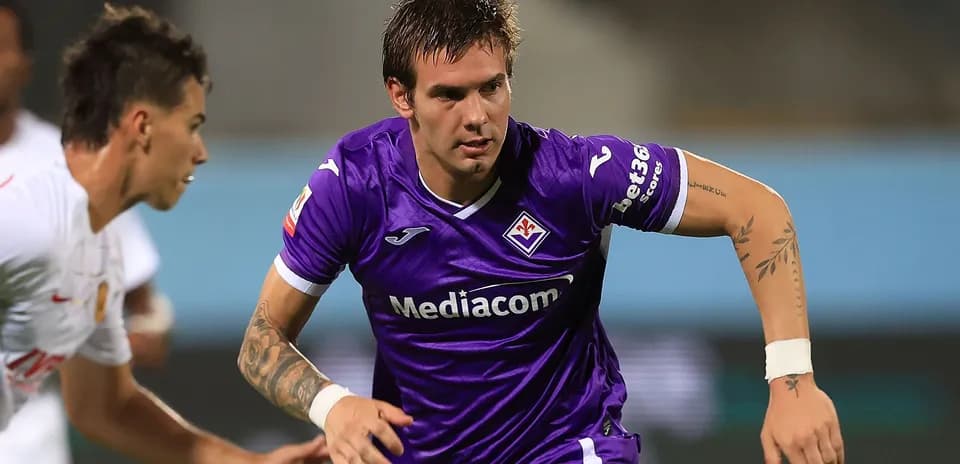 Player in purple jersey running during a match