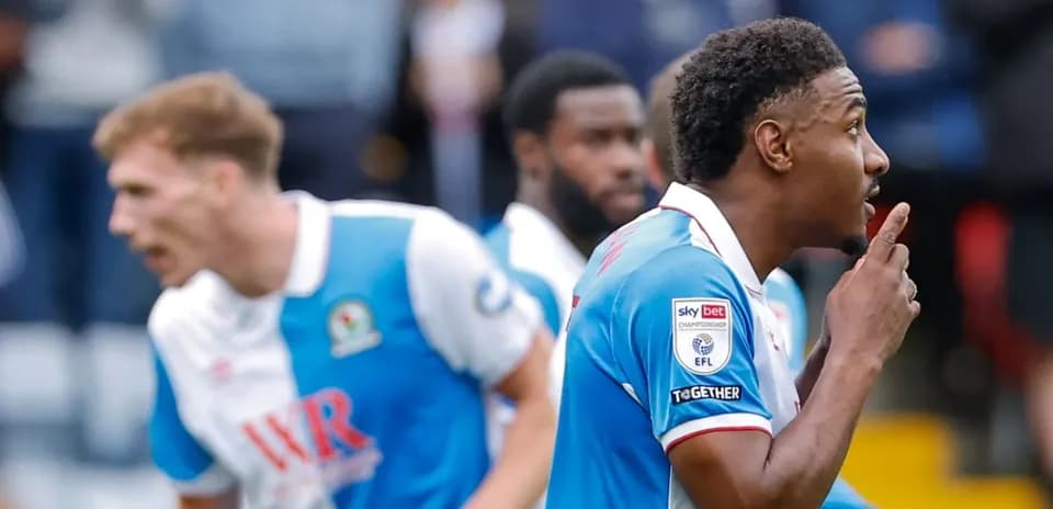 Player celebrating goal with shushing gesture during match