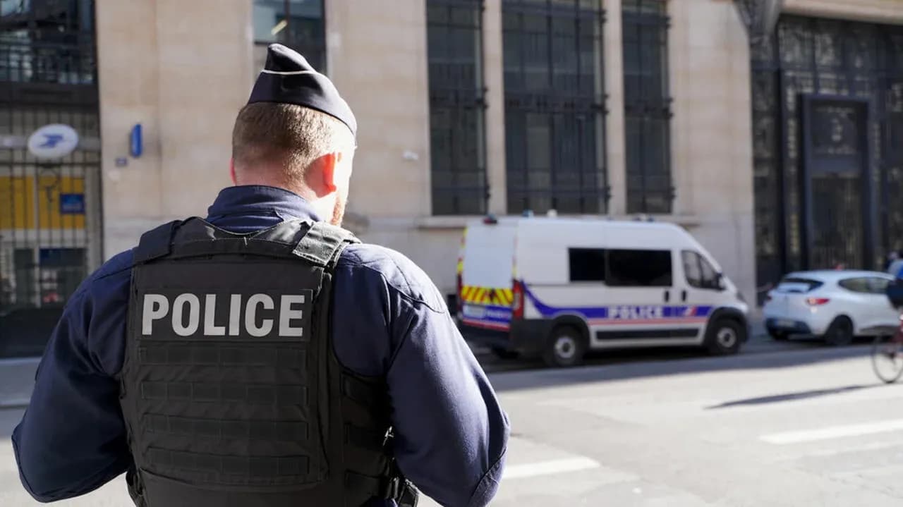 Police officer observing scene near police van