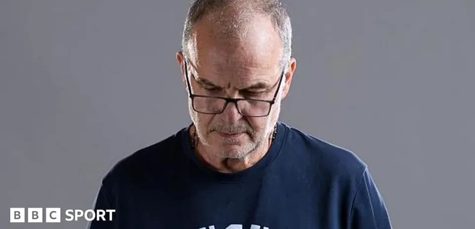 Man with glasses looking down thoughtfully
