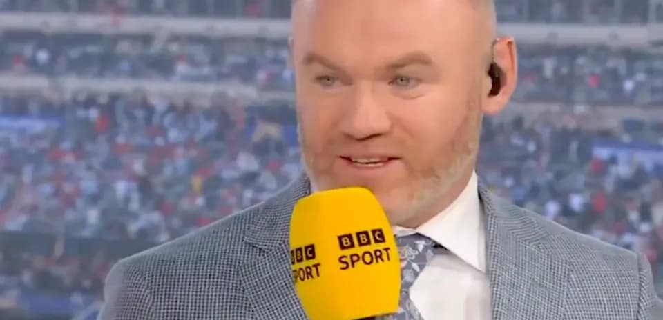Sport analyst speaking into microphone during broadcast