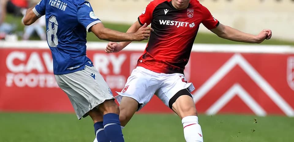 Players from Cavalry FC and HFX Wanderers in action