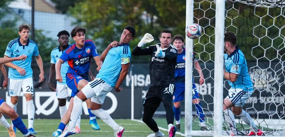 Players competing for the ball near the goal