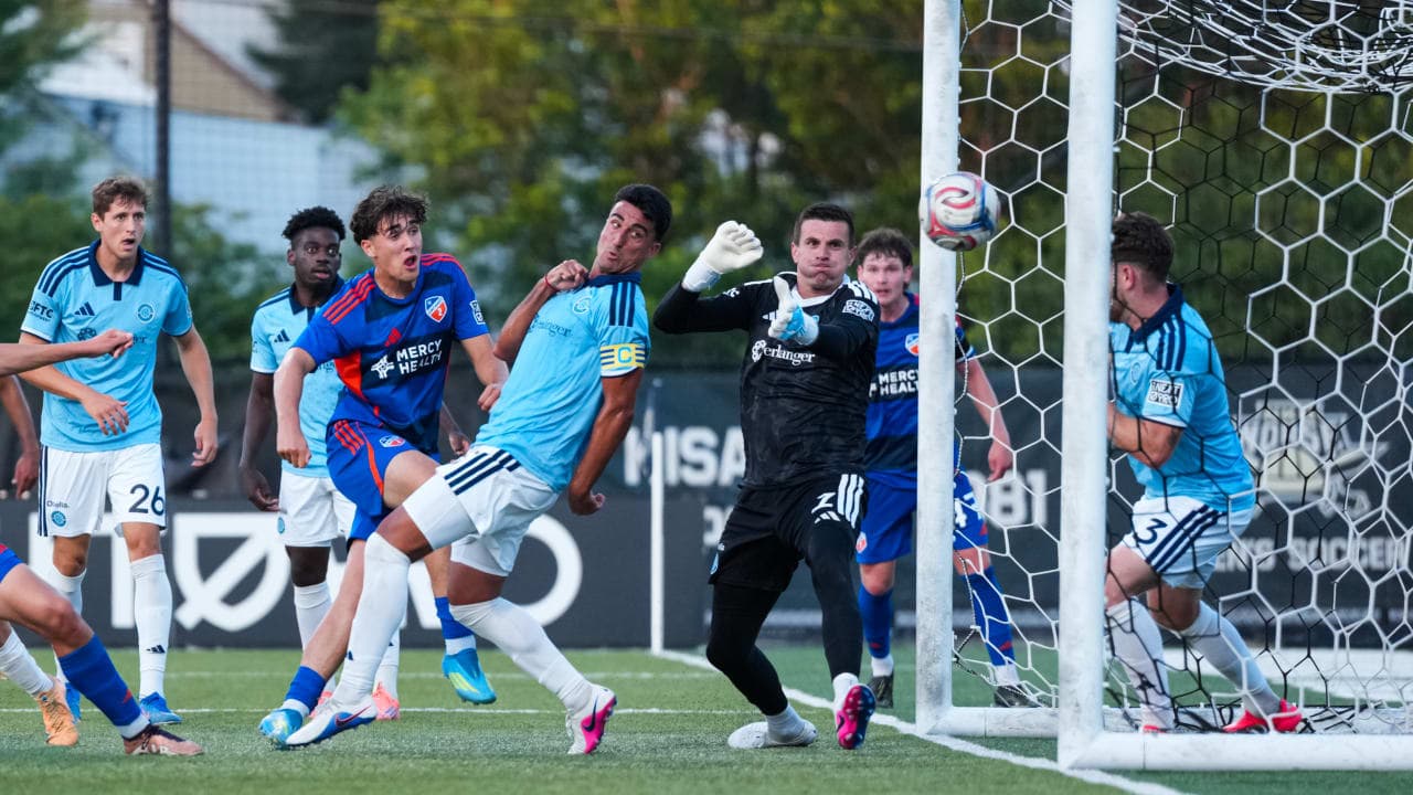 Players competing for the ball near the goal