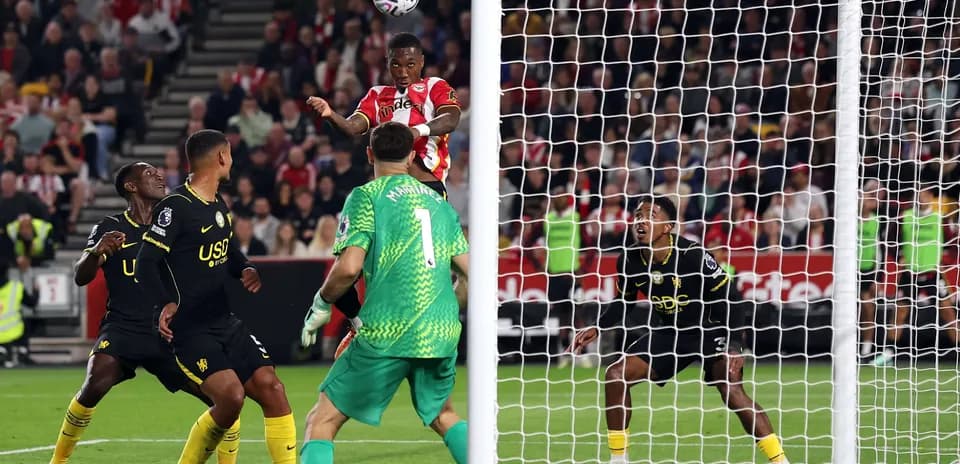 Brentford player heading the ball towards goal