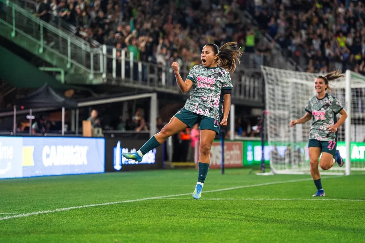 Player celebrating goal during Seattle Reign FC match