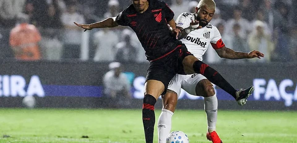 Player challenging for the ball during rainy match