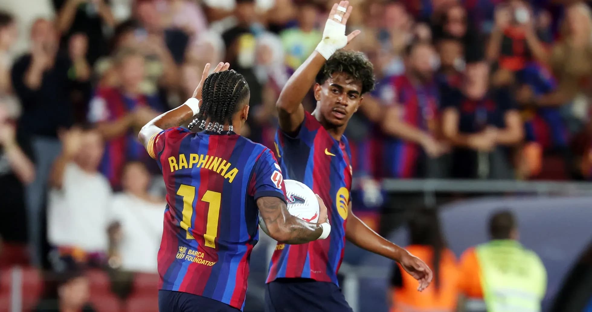 Raphinha celebrating with teammate after a play