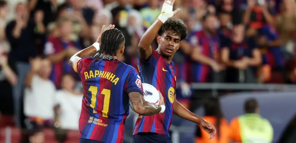 Raphinha celebrating with teammate after a play