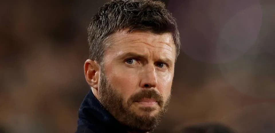 Man with a beard looking intently off-camera
