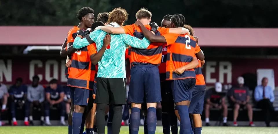 Soccer team huddled together before match