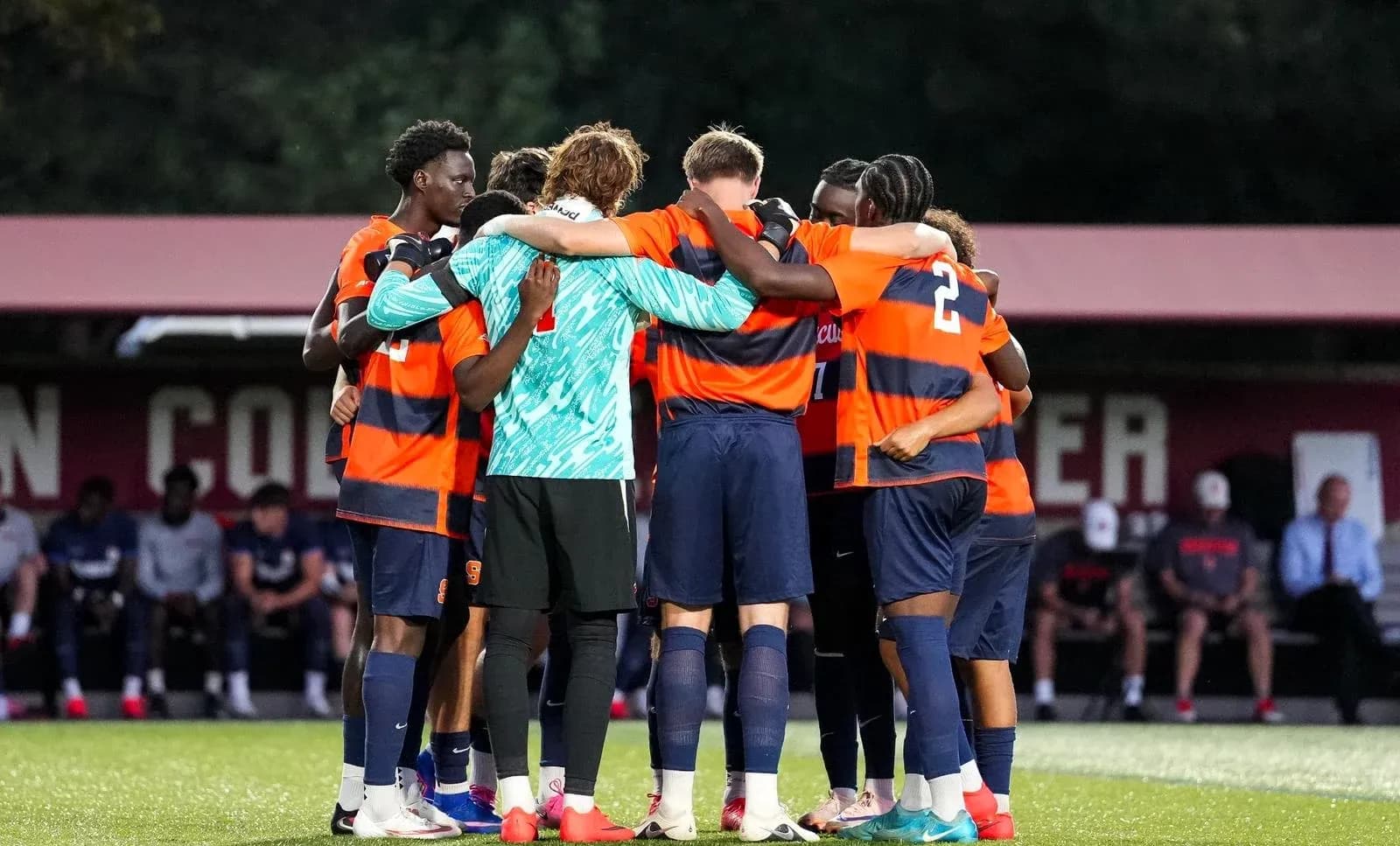 Soccer team huddled together before match
