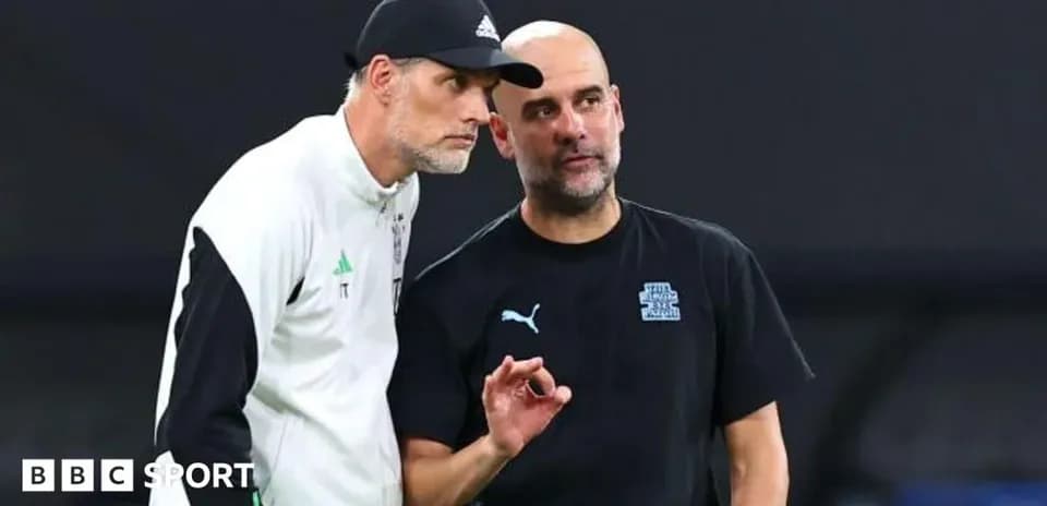 Two football managers discussing on the sidelines