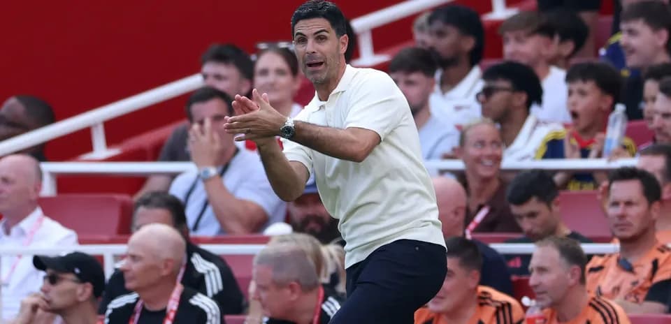 Manager gesturing from the sidelines during match