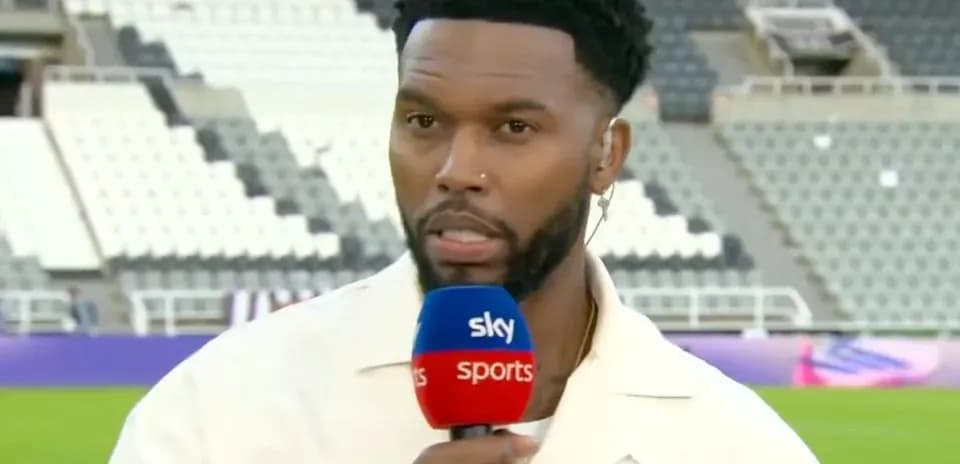 Sports commentator speaking into microphone on field