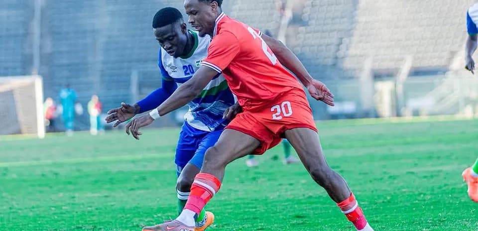 Two players competing for the ball during soccer match
