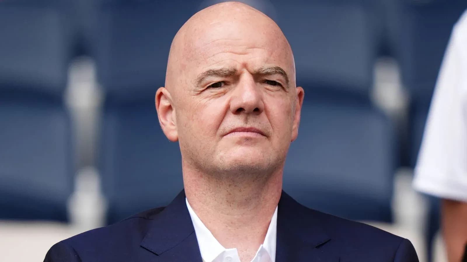 Man in suit seated at an event