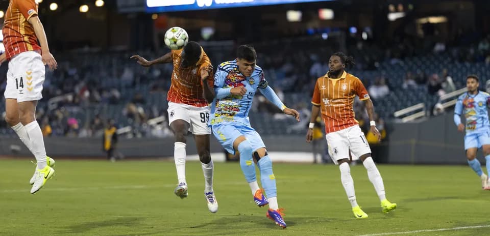 Players competing for the ball during match