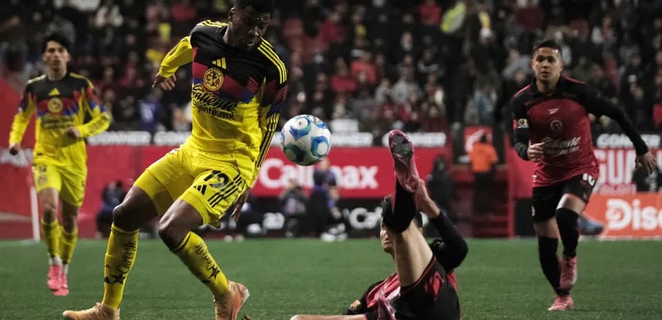 Club America player dribbling during Liga MX match