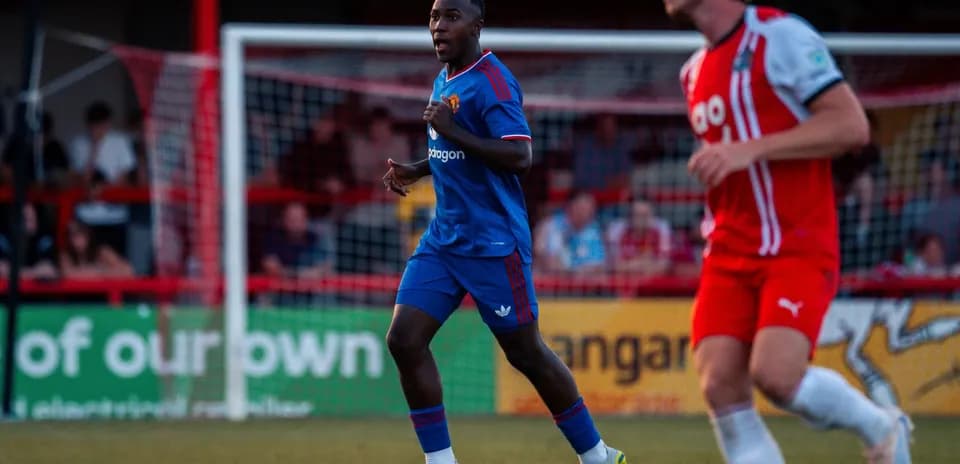 Player in blue jersey running on the field