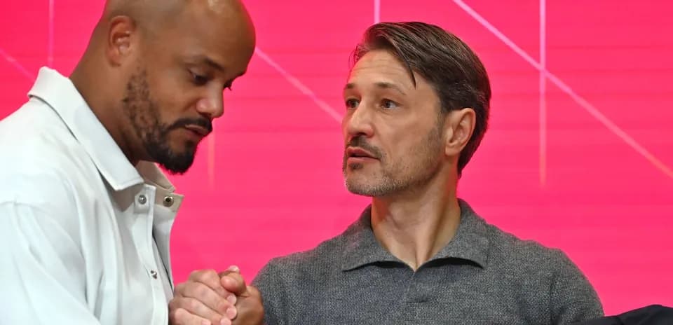Two men shaking hands at a press conference
