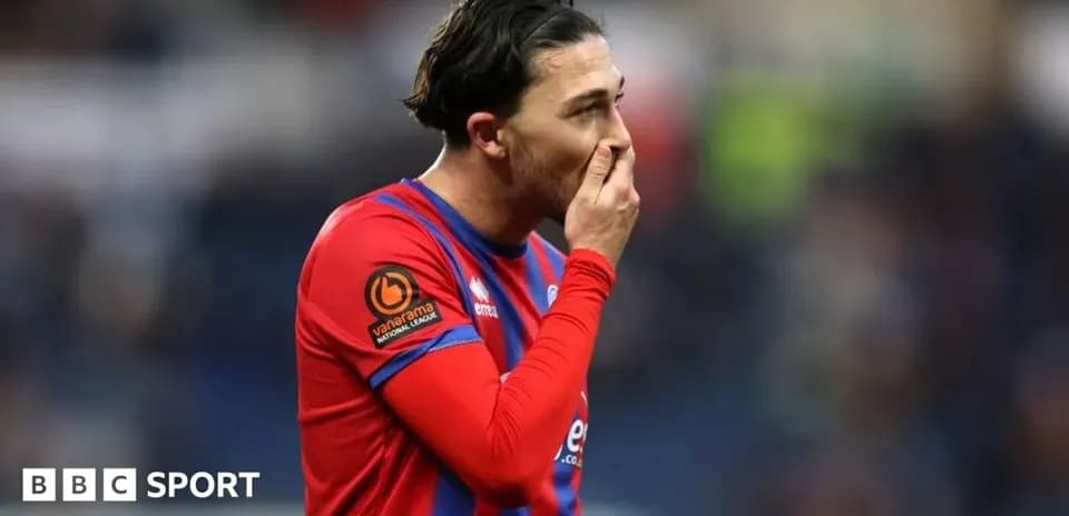 Player in red and blue jersey during match