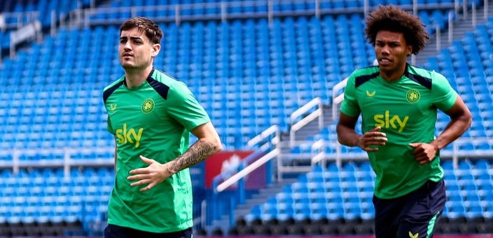 Two players jogging during training session on field