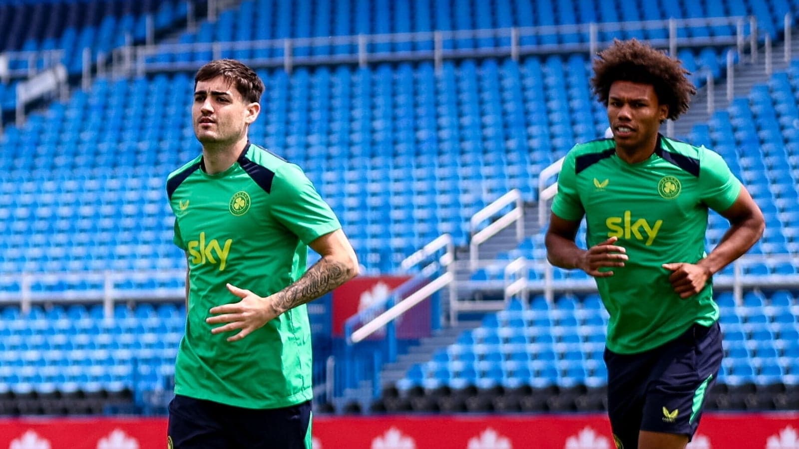 Two players jogging during training session on field