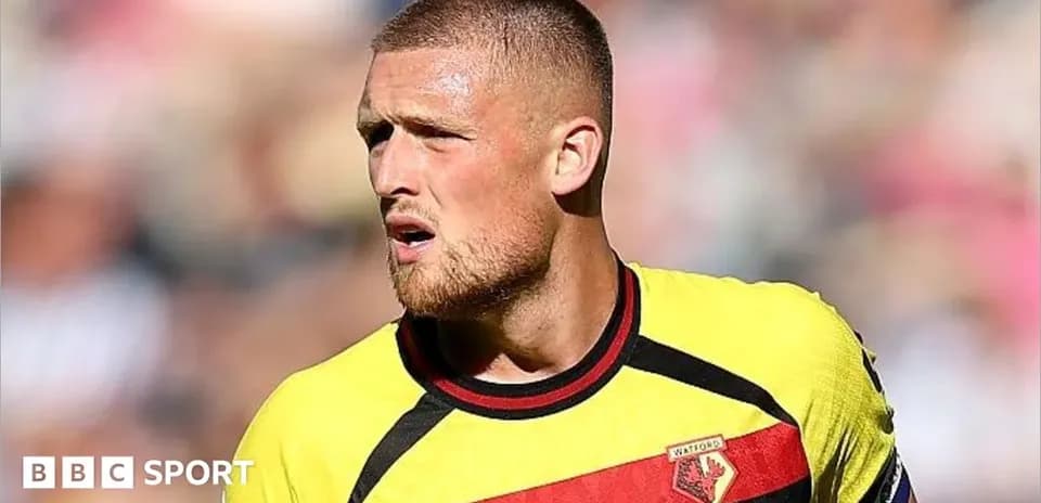 Watford player in yellow and red jersey during match