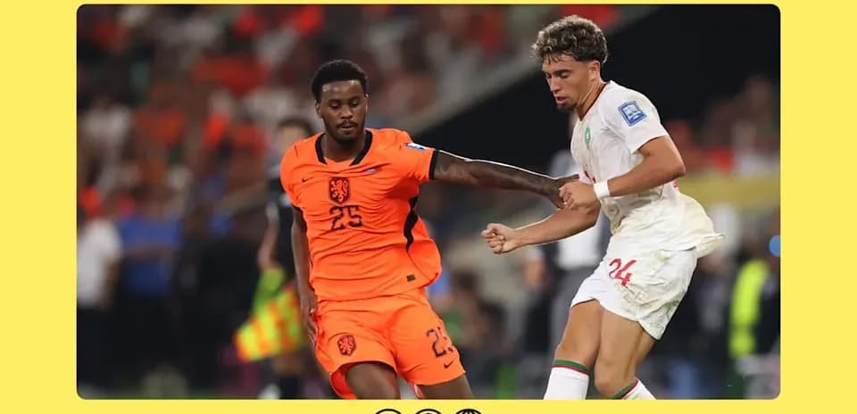 Players from Netherlands and Morocco competing for possession