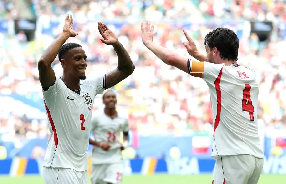 Two England players celebrating a goal during match