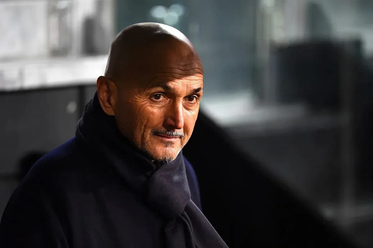 Coach wearing a dark scarf in stadium setting