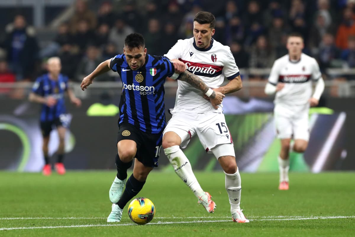 Bologna player challenging Inter player for the ball