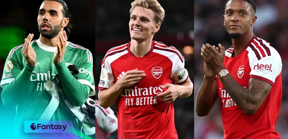 Three Arsenal players applauding fans during match