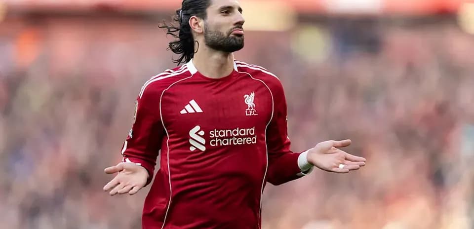 Player gesturing during match in Liverpool jersey