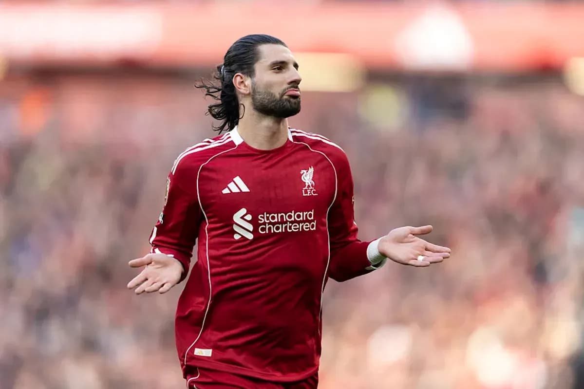 Player gesturing during match in Liverpool jersey