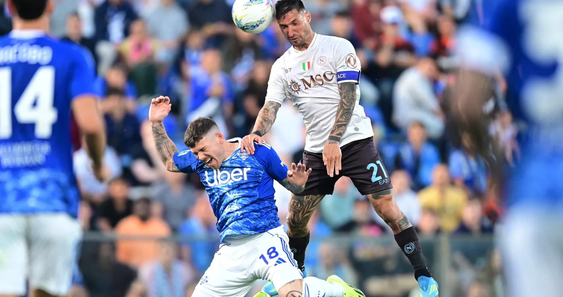 Napoli player challenging Como player in match