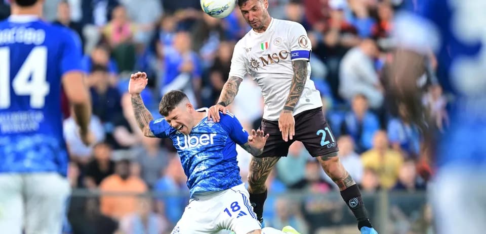 Napoli player challenging Como player in match