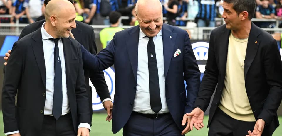 Three officials interacting on the pitch before match