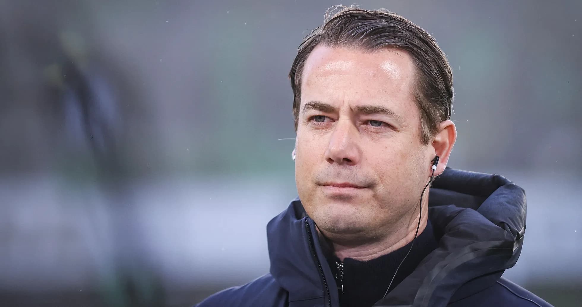 Coach wearing headphones during a match