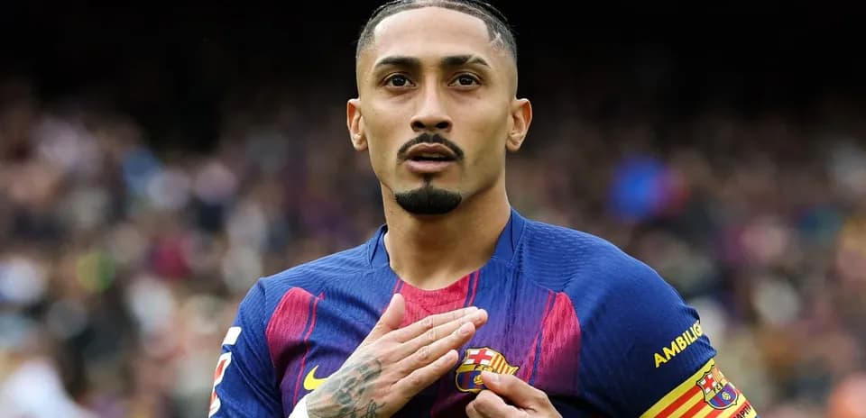 Player placing hand on FC Barcelona badge
