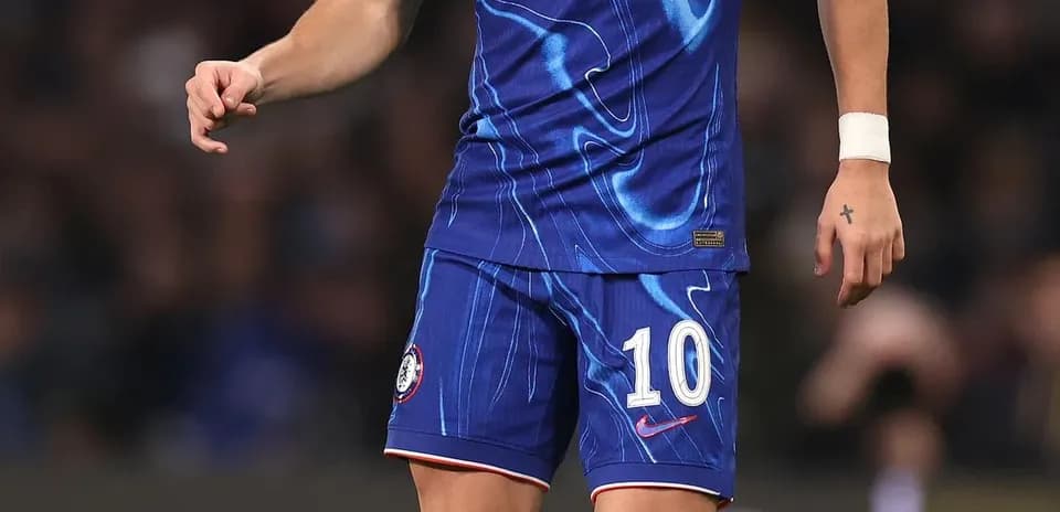 Player in Chelsea kit preparing to kick ball