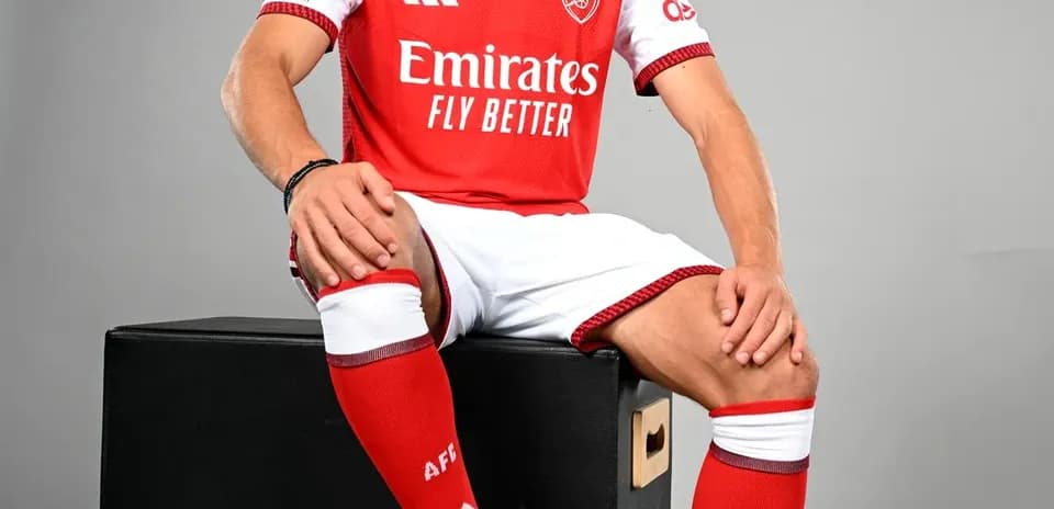 Player in Arsenal kit sitting on black box